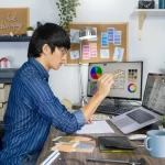 asian-graphic-designer-designing-layout-selection-renovation_357951-9